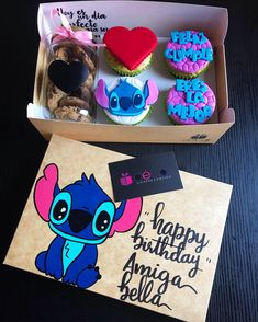 a box with some cupcakes and cookies in it