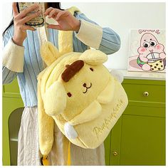 This Pompompurin backpack is more than just a carry item; it’s a nod to all things cute and playful in the kawaii culture. Its plush exterior promises comfort and adds a dash of charm to any ensemble, making it an ideal pick for those who adore cute anime bags. Designed to delight fans of all ages, this pompompurin plush backpack is your go-to for a mix of fun and functionality, ensuring you or your little one shines in any crowd. Dive into the cute world of kawaii with the Pompompurin Plush Backpack, the perfect accessory for anime lovers and anyone seeking a unique kids backpack. This plush bag stands out by showcasing the beloved character Pompompurin, blending whimsy and practicality. It’s not just any pompompurin bag; it’s a statement piece that elevates your style and keeps essential Pompompurin Backpack, Big Squishies, Cute Pompompurin, Pompompurin Plush, Cute Bed Sheets, Pompom Purin, Kawaii Culture, Pom Purin, Silly Clothes