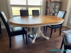 a dining room table with four chairs around it