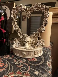 a heart shaped mirror sitting on top of a table next to a bottle of wine