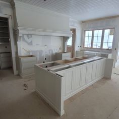 an unfinished kitchen with white cabinets and drawers in the process of remodeling