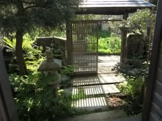 an outdoor garden with stone steps leading up to a gazebo in the middle of it