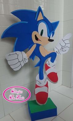 a paper model of sonic the hedgehog on display in a tiled room with white tile walls