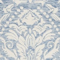 a blue and white rug with an intricate design