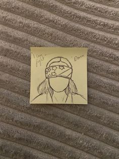 a piece of paper with a drawing of a girl wearing a bandana on it