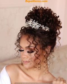 a woman with curly hair wearing a tiara