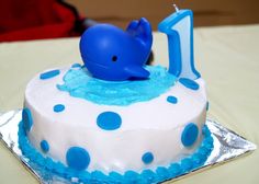 a blue and white birthday cake with a dolphin on top