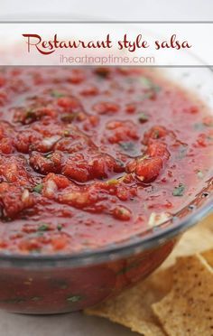 a bowl of salsa with tortilla chips on the side