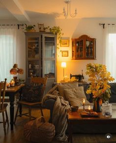 a living room filled with furniture and lots of flowers on top of a wooden table