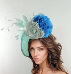 Aqua Dark Turquoise Blue Saucer Disc Kentucky Derby Fascinator Hat Ascot Wedding Hatinator Cocktail Formal Womens Races Tea Party Hats Faith Fascinator Hat Large turquoise blue sinamay base trimmed with gorgeous aqua feathers finished off with aqua and dark turquoise flowers Base measures about 12 inches wide  This aqua and turquoise hatinator is mounted with a matching headband. If you prefer a headband to match your hair, please make a note at check out what colour headband you want. This fasc Light Blue Headpiece For Royal Ascot Party, Light Blue Headpiece For Kentucky Derby Party, Elegant Blue Fascinator With Handmade Flowers, Blue Mini Hats With Handmade Flowers For Royal Ascot, Blue Hats With Handmade Flowers For Kentucky Derby, Light Blue Mini Hat For Kentucky Derby Party, Elegant Blue Headpiece With Handmade Flowers, Elegant Turquoise Summer Hat, Summer Blue Headpiece With Handmade Flowers