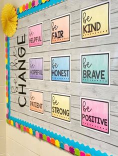 a bulletin board that has been decorated with colorful stickers and writing on the wall