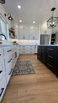 #customcabinets #customcabinetry #shakercabinets #customkitchen #whitekitchen #whitekitchencabinets #calacatta #calacattaquartz #calacattalaza #tricornblack #sherwinwilliams #sherwinwilliamspurewhite #sherwinwilliamstricornblack #coretecflooring #modernfarmhouse #ltkhome #kitchensofinstagram #calypsooak #blackandwhitekitchen #neutralhome #neutraldecor #blackandwhite #minimalisthome #countrykitchen #cloetile #modernkitchens #amazon #amazonhome #amazonhomefinds #target Kitchen Cabinets Black Hardware, White Kitchen Cabinets Black Hardware, Kitchen Cabinets With Black Hardware, High Kitchen Cabinets, White Cabinets Black Hardware, Cabinets With Black Hardware, Black Hardware Kitchen, Barndominium Kitchen, Black And White Cabinets