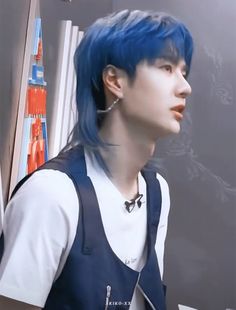 a young man with blue hair and piercings