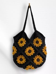 a crocheted sunflower bag hanging from a hook on a white wall,