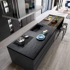 a modern kitchen with an island countertop and stainless steel appliances in the center area