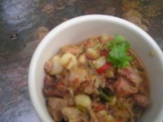 a white bowl filled with food on top of a table