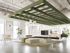 an open living room with white walls and green beams on the ceiling, while people are sitting at tables in the background