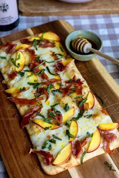 a wooden cutting board topped with slices of pizza