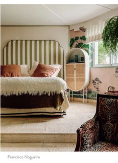 a bedroom with an animal print chair and bed