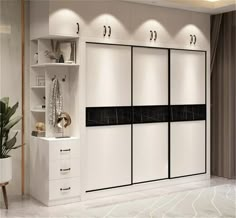 a white and black closet in a room next to a potted plant on a table