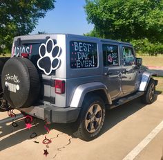 a jeep parked in a parking lot with the word best day ever written on it