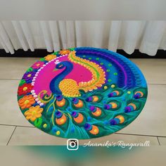 a colorful peacock rug sitting on top of a tile floor