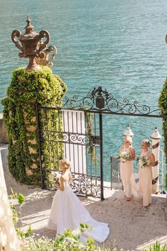 the bride and her bridesmaids are getting ready to walk down the stairs by the water