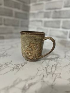 a coffee cup sitting on top of a marble counter