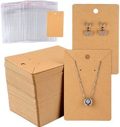 the package includes two necklaces, earrings and an envelope with clear plastic bags on it