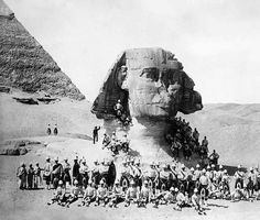 a group of people standing in front of the great sphinx