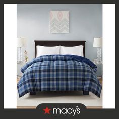 a blue and white plaid comforter on a bed