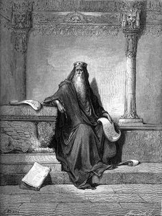 an old man with a long beard sitting on the steps in front of a column