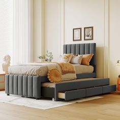 a bed that is sitting on top of a hard wood floor in a room with white walls