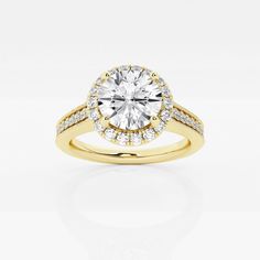 a yellow gold engagement ring with diamonds on the band and a center stone in the middle