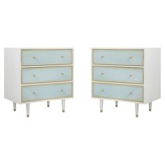 two white and gold dressers side by side against a white background with no one in it