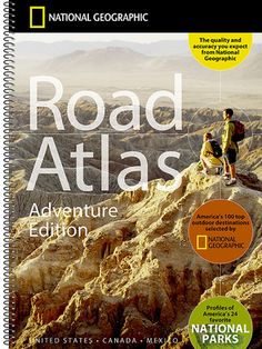 a book with the title road atlas adventure edition written in black and yellow, on top of a rocky outcropping