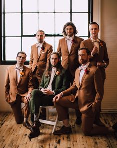 a group of men in suits and ties sitting next to each other on a chair