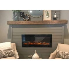 a living room with two chairs and a fire place in the center, along with a fireplace