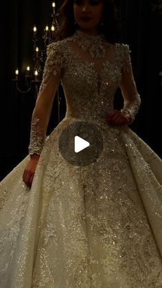 a woman in a wedding dress standing next to a chandelier filled with lights