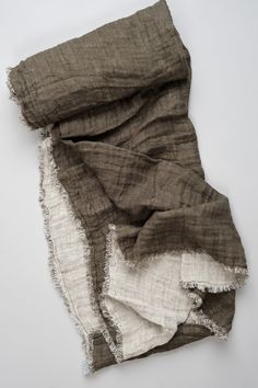 an old piece of cloth with torn edges on a white surface, showing the fraying