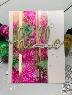 a card with the word hello written on it and some crafting supplies around it