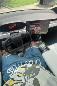 a man laying in the back seat of a car