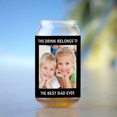 a glass jar with an image of two children on it and the caption reads, this drink belongs to the best dad ever