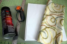 sewing supplies are laid out on a cutting board next to a measuring tape and scissors