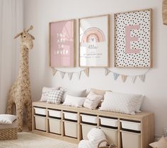 a child's room decorated in pink, white and neutrals with pictures on the wall