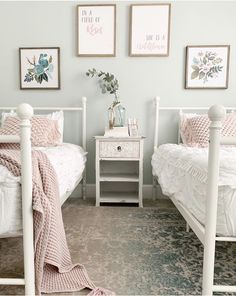 two twin beds in a bedroom with pink and white decor