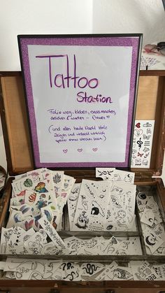 an open suitcase filled with lots of tattoos on it's sides and writing that says tattoo station