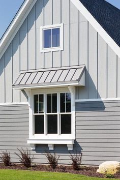 a gray house with white trim and windows