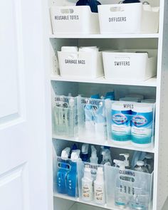 an organized pantry with white bins filled with cleaning products