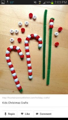 some candy canes are sitting on a table with pins in the shape of letters